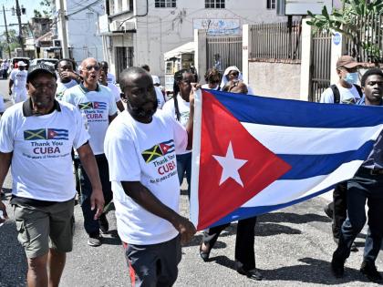 Jamaicans on a 'gratitude walk' in Kingston on March 17, 2026, thanking Cuban medical professionals for their contributions to the local public health system over the last 50 years. Jamaica ended the cooperation programme in March. 