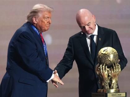 FIFA President Gianni Infantino (right) presents President Donald Trump with the FIFA Peace Prize during the draw for the 2026 football World Cup at the Kennedy Center in Washington on Friday, December 5, 2025. 