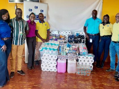 NWC representatives share a moment with Manning’s Boys Home after donating essential items to the institution. In photo from left are;  Shanique Brown, team leader - distribution and maintenance (Control Center); Richard Aiken, manager, Manning’s Boys 