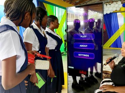 Students from St Thomas Technical High School engage with newly launched NEPA educational games during the National School Environmental Club Programme Workshop, guided by Senior Public Education and Community Outreach Officer, Ava Tomlinson.