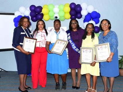 Nurse of the Year, Fione Collins (third right), shares a photo opportunity with recipients of her IWIN Project. Pictured with her are Donna Burton of the Women’s Centre of Jamaica Foundation in Mandeville; Kiyanna Sappleton of Edwin Allen High School (th