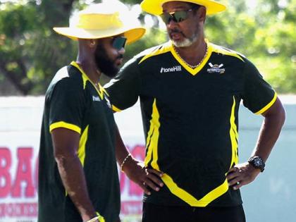Jamaica Scorpions coach Robert Haynes (right) chats with captain John Campbell during the West Indies Championship cricket match against Barbados Pride at Chedwin Park on Wednesday.