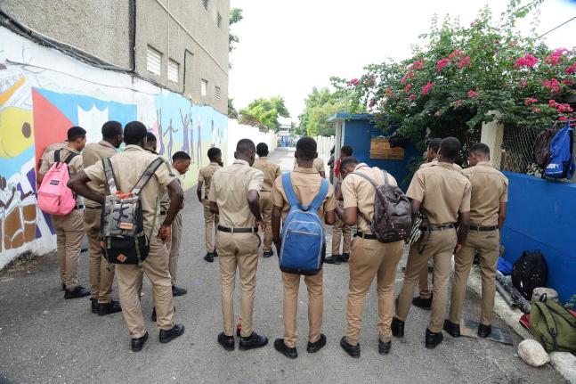 In this file photo, a group of students  is seen standing at their school gate.