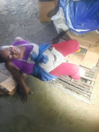 Dorey McPherson awaiting the arrival of firefighters to free her trapped leg after several failed efforts by passers-by who rushed to her aid.