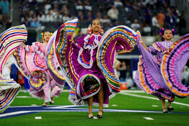 A folklorico dance group performs at half-time of an NFL football game between the Baltimore Ravens and Dallas Cowboys in Arlington, Texas in September 2024.