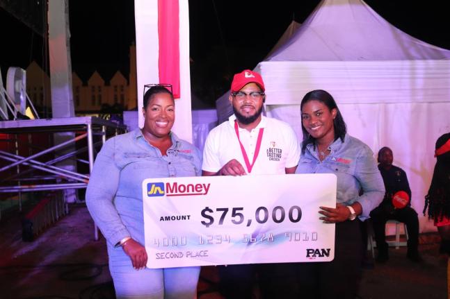 Sanya Wallace-Innerarity (left), assistant general manager – strategy, marketing and sales, JN Money; and Cedrica Reid (right), marketing and sales manager, JN Money, celebrate with second place winner, Mobolji Bryan, in the CB PAN Chicken Competition he