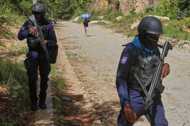 Police officers patrol the area near the Sainte-Hélène orphanage in the Kenscoff neighbourhood of Port-au-Prince, Haiti.