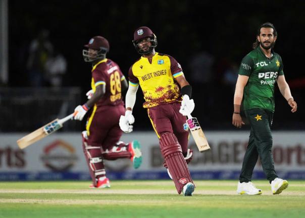 West Indies’ Shai Hope (centre) runs between the wickets with Sherfane Rutherford (left) during the second Twenty20 cricket match against Pakistan on August 2.