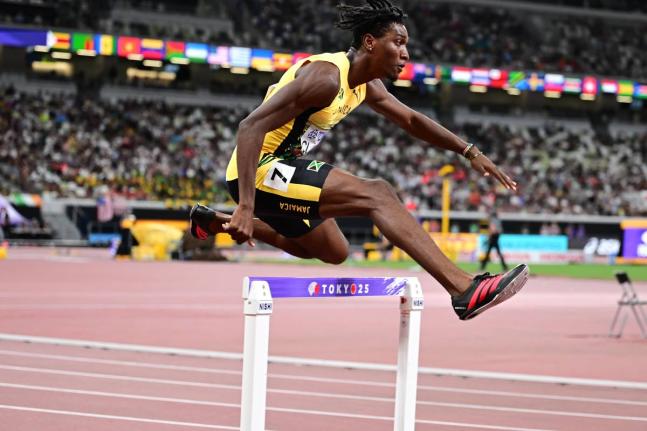 Jamaica’s Roshawn Clarke cleares a hurdles during his me’s 400-metre hurdles heat at the World Athletics Championships inside the Japan National Stadium in Tokyo yesterday. 