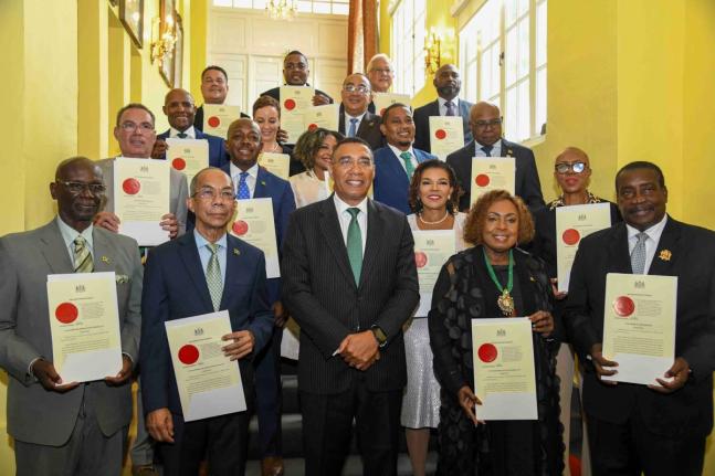 The Prime Minister and members of his cabinet pose for a photo: In front row (from left) are: Desmond McKenzie; Dr. Horace Chang; Prime Minister Dr. Andrew Holness; Olivia Grange; Robert Montague. Second Row: Daryl Vaz; Pearnel Charles Jr; Audrey Marks; Da