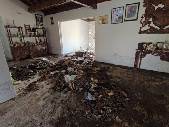 The resident said the water broke the glass door on her house, toppling furniture and leaving the entire house in a mess.