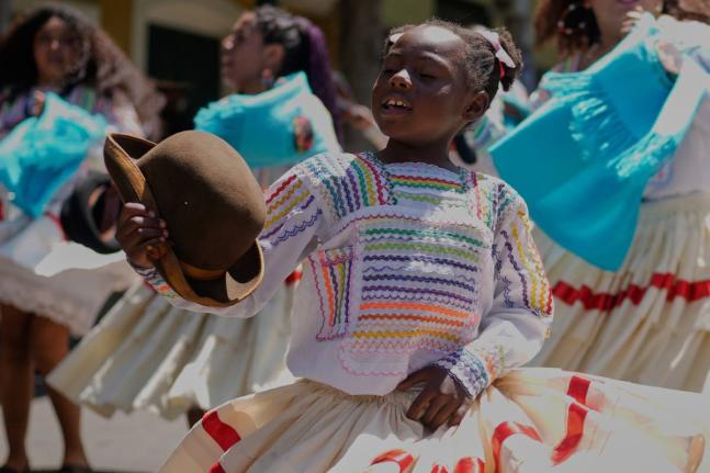 A young member of the Afro-Bolivian community dances the ‘saya’, a traditional dance performed with drums and chants, as part of the celebrations to mark the National Day of Afro-Bolivian people, in La Paz.