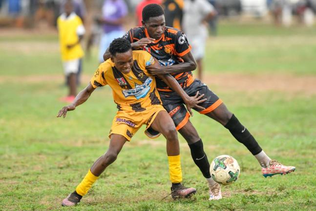 Jerome Clarke (left) of Haile Selassie High tries to keep the ball from Jahiem Fuller of Tivoli High during their Manning Cup match on Thursday at Tivoli. The game ended in a 2-2 draw. 