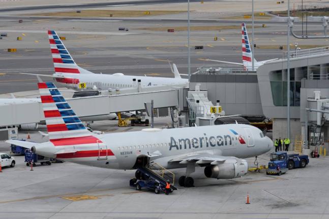 American Airlines planes sit on the tarmac at LaGuardia Airport, January 11, 2023, in New York.