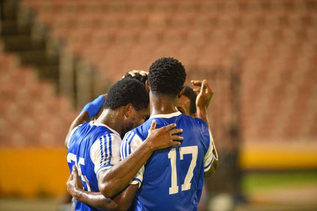 Mount Pleasant Academy players celebrate Ranaldo Biggs’ goal against O&M Football Club during Concacaf Caribbean Cup match  at the National Stadium on September 30.
