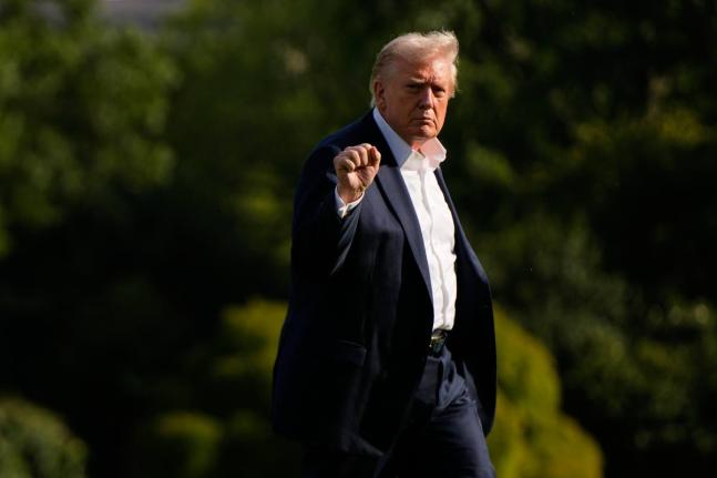 President Donald Trump gestures as he arrives at the White House, Friday, September 26, 2025, in Washington. (AP Photo/Julia Demaree Nikhinson)