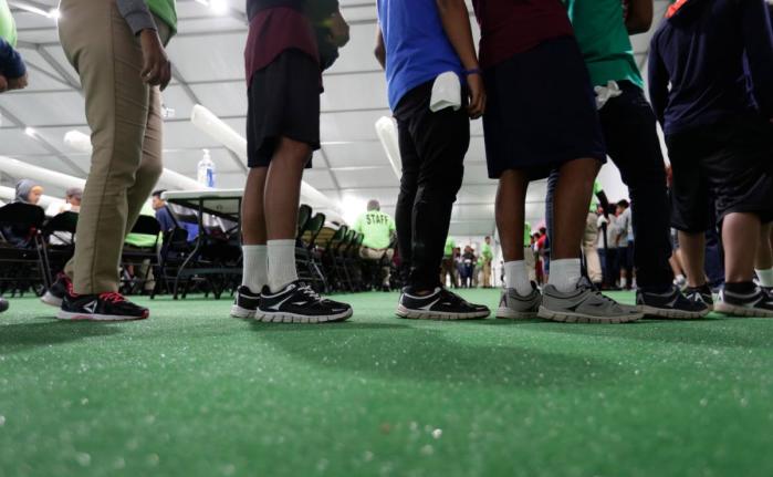 Immigrants line up in the dining hall at a new US government holding centre for migrant children in Carrizo Springs, Texas, on July 9, 2019. (AP Photo/Eric Gay, File)