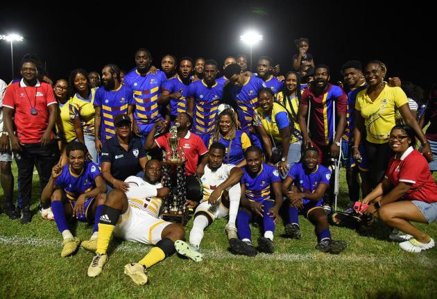 Members of the RJRGLEANER team celebrate winning the KSAFA Business House Division One football title with their fans at Ashenheim Stadium, Jamaica College, on October 4.