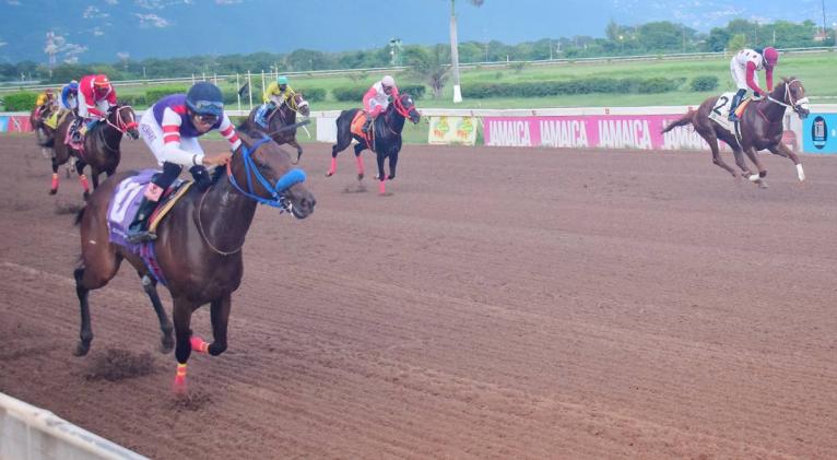 BOOTYLICIOUS (left), ridden by Raddesh Roman, wins Division One of the Nigel Nunes Memorial Cup ahead of PRINCE AMANN (right, Robert Halledeen) at Caymanas Park yesterday.