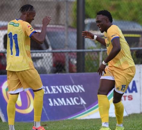 Molynes United’s Wisdom Ubani (right) and teammate Rashawn Livingston celebrate after Ubani scored his second goal against Spanish Town Police FC during their Jamaica Premier League match yesterday.
