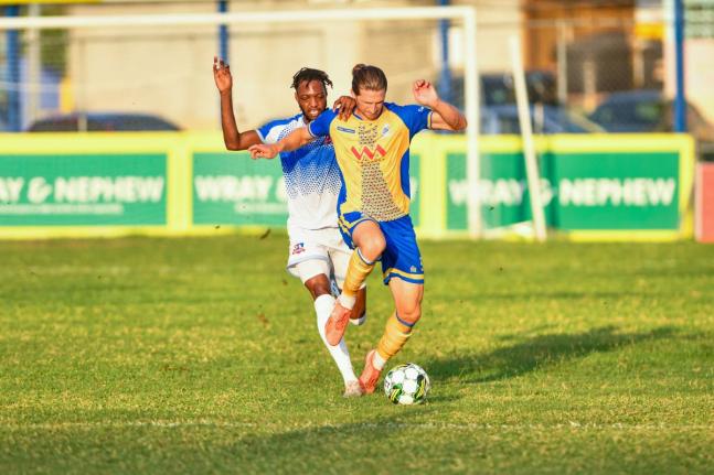 Dunbeholden’s Nicholas Nelson (left) challenges Harbour View’s Alexander Jacobs at the Jamaica Premier League at Drewland yesterday. Harbour View 1-0.