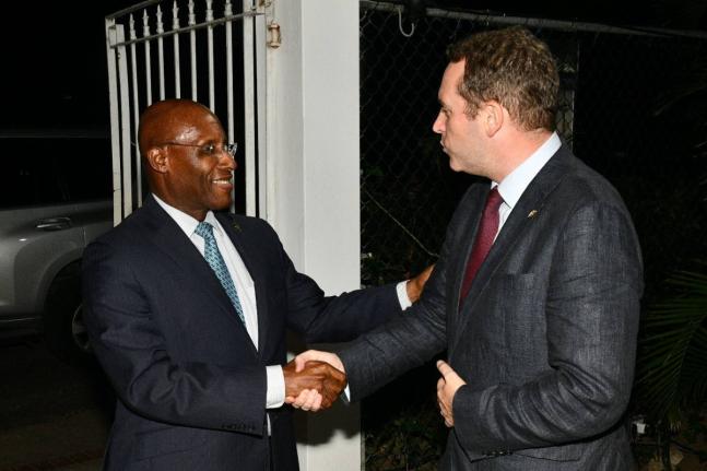 Minister of Industry, Investment and Commerce, Senator Aubyn Hill (left), greets Deputy British High Commissioner to Jamaica, Jonathan Cook, as he arrives at a welcome reception for the visiting United Kingdom Trade Mission to Jamaica on Wednesday, October