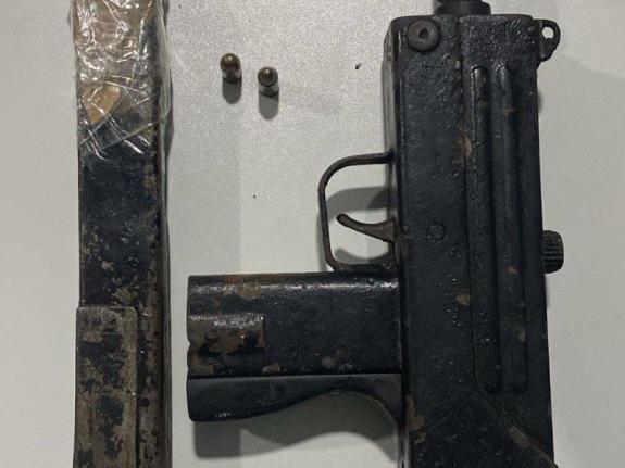 During a search of the area, the lawmen discovered a Mac 11 submachine gun loaded with a magazine containing two live rounds. 