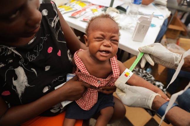 A malnourished child is checked on by a doctor from a travelling pharmacy at a shelter for families displaced by gang violence in Port-au-Prince, Haiti, Tuesday, October 7, 2025. (AP Photo/Patrice Noel)