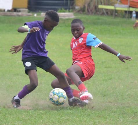 Sts Peter and Paul’s Djau Samuels (left) is tackled by Lannaman’s Dervon Dixon during the 