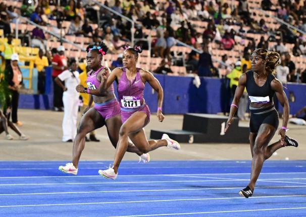 From left: Serena Cole, Tia Clayton, and Shashalee Forbes compete in a women’s 100m event at the Gibson McCook Relays inside the National Stadium in February.