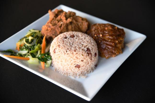 Rice and peas with fried chicken and steamed vegetables.