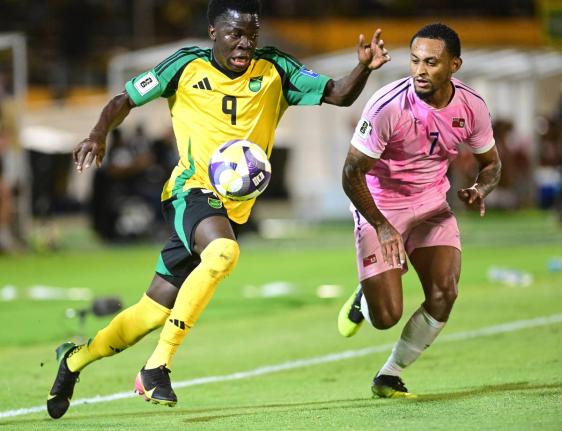 Jamaica’s Kaheim Dixon (left) dribbles by Bermuda’s Lejaun Simmons during their Concacaf World Cup Qualifier on October 14. 