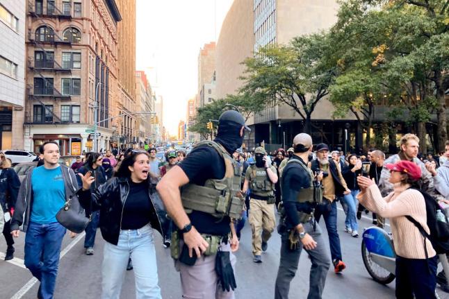 Protesters confront Federal agents as they walk down Lafayette Street after an immigration sweep on Canal Street through Chinatown, Tuesday, October 21, 2025, in New York. (AP Photo/Jake Offenhartz)