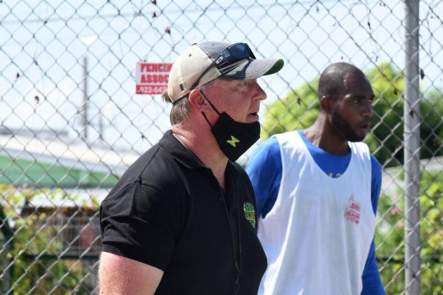 National basketball team head coach Rick Turner (left) gives instructions to members of  the national team during a training session at the Stadium Courts.