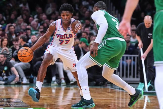 Philadelphia 76ers guard VJ Edgecombe (77) drives to the basket against Boston Celtics guard Jaylen Brown (7) during the second half of an NBA basketball game, Wednesday, October 22, 2025, in Boston. 