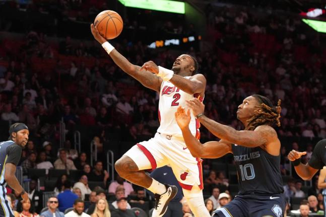Miami Heat guard Terry Rozier (2) drives to the basket as Memphis Grizzlies guard Javon Small (10) defends during the second half of an NBA preseason basketball game Friday, October 17, 2025, in Miami. 