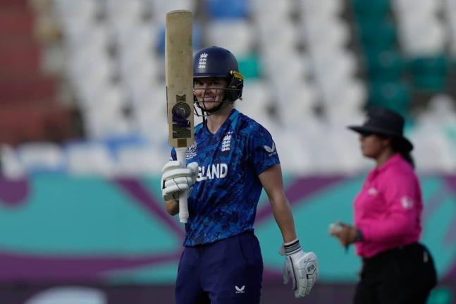 England’s Amy Jones celebrates after reaching 50 during the ICC Women’s World Cup match between England and New Zealand at ACA–VDCA Cricket Stadium in Visakhapatnam, India yesterday.