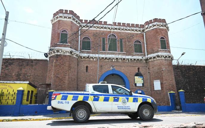 A police patrol car passes the Tower Street Adult Correctional Centre in downtown Kingston on March 14, 2024.