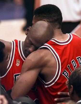 The Chicago Bulls’ Michael Jordan collapses in the arms of teammate Scottie Pippen (right) at the end of Game 5 of the NBA Finals against the Utah Jazz on June 11, 1997, in Salt Lake City. 