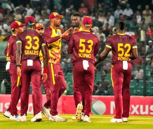 Photo courtesy CWI Media 
Jason Holder (third right) celebrates with teammates from left: Alick Athanaze, Jayden Seales, Shai Hope, Roston Chase, Brandon King and Rovman Powell after taking a wicket, during the second T20I at the Bir Sreshtho Flight Lieute