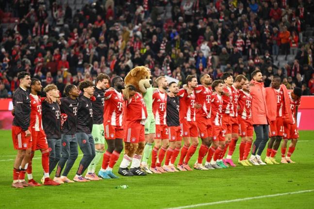 Bayern Munich players celebrate their victory after the Bundesliga match between Bayern Munich and Borussia Dortmund in Munich, Germany, Saturday, October 18, 2025. 