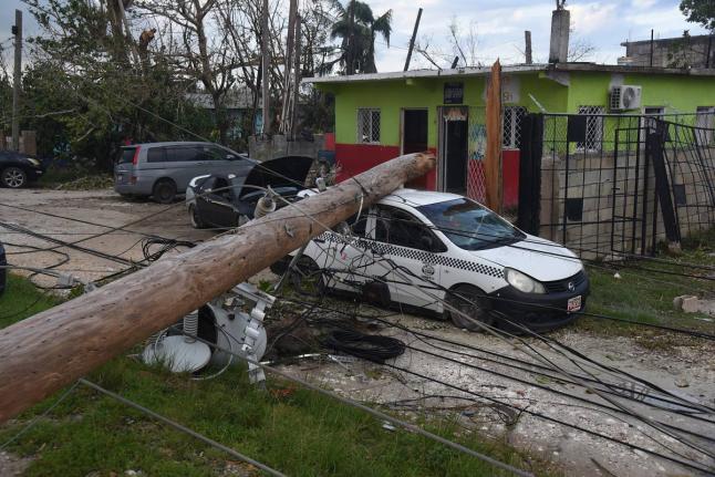 A utility pole which broke during the passage of Hurricane Melissa fell on a parked car in Salt Marsh, Trelawny.