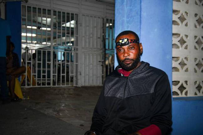 
Mortician Dywite Spence, a worker at Doyley’s Funeral Service, takes a break at 3 a.m. on Thursday at the Savanna-la-Mar Public General Hospital in Westmoreland after spending the last 10 hours retrieving the bodies of hurricane victims across the paris