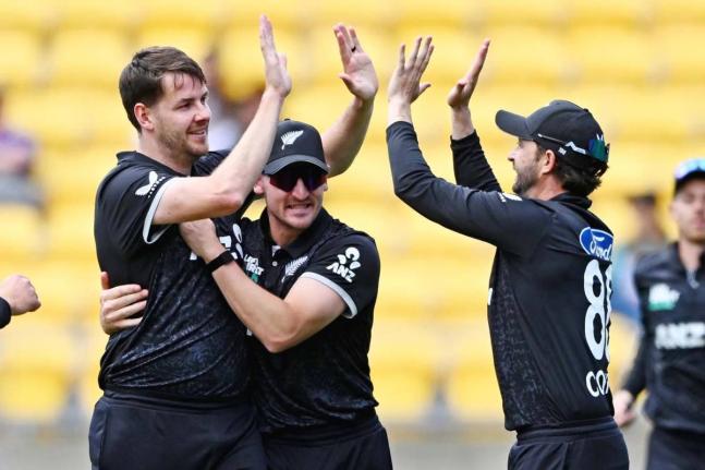 
Jacob Duffy (left), Nathan Smith and Devon Conway of New Zealand celebrate the wicket of joe Root during the One Day International cricket match in Wellington, New Zealand, yesterday.