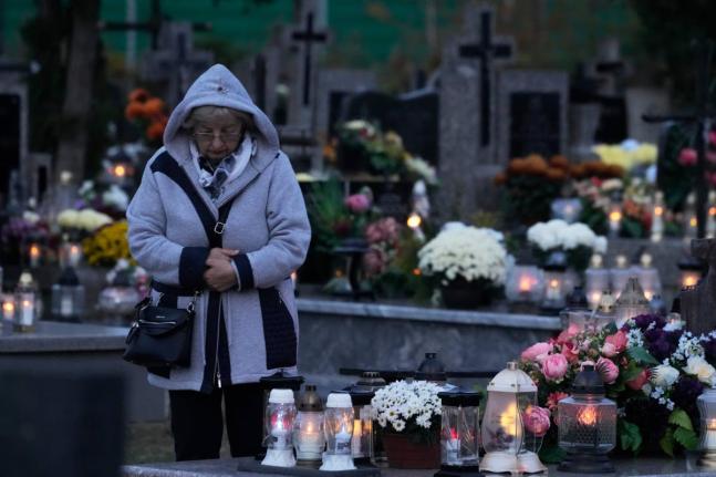 A woman observes All Saints’ Day, a time for reflecting on those who have died, in Kroczewo near Warsaw, Poland.