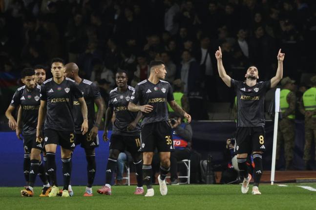 Qarabag’s players celebrate their side’s second goal scored by Qarabag’s Marko Jankovic (right) from the penalty spot during the Champions League opening phase football match against Chelsea in Baku, Azerbaijan, yesterday.