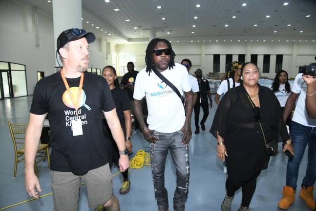 Dancehall artiste Vybz Kartel (centre) touring the World Central Kitchen (WCK) worksite at the Montego Bay Convention Centre in St James with members of his team from the Adidja Palmer Foundation along with WCK response director, John Torpey (left), on Nov