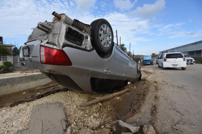 A car sits on its roof in Catherine Hall, a community in Montego Bay where homes, businesses and infrastructure suffered heavy damage due to Hurricane Melissa.