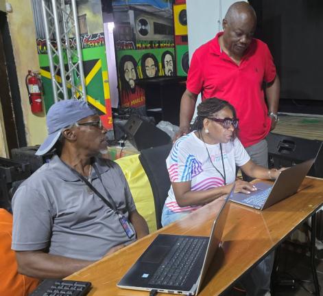 President of the Western Jamaica Media Association, Janet Silvera (centre) in conversation with her vice president, Garwin Davis (right) and veteran journalist Adrian Frater while at work at the newly installed media centre at S Hotel Montego Bay. 