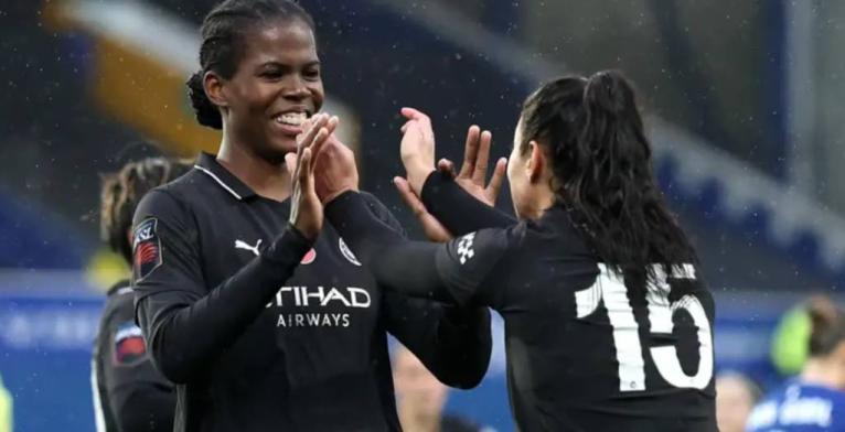 Khadija Shaw (left) celebrates after scoring the winner for Manchester City against Everton yesterday.